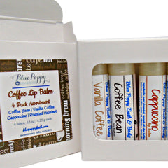 Coffee lip balm tubes with white labels, brown text, and Blue Poppy branding in a white box