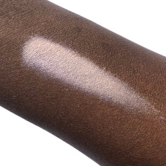 Hand applying shimmery taupe mineral eyeshadow with fingertip for a smooth, crease-free finish