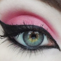 Eye makeup with pink eyeshadow, black eyeliner, and long eyelashes