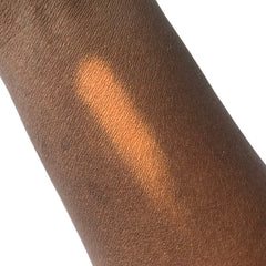 Skin tone swatch showing brown skin with orange color application on arm