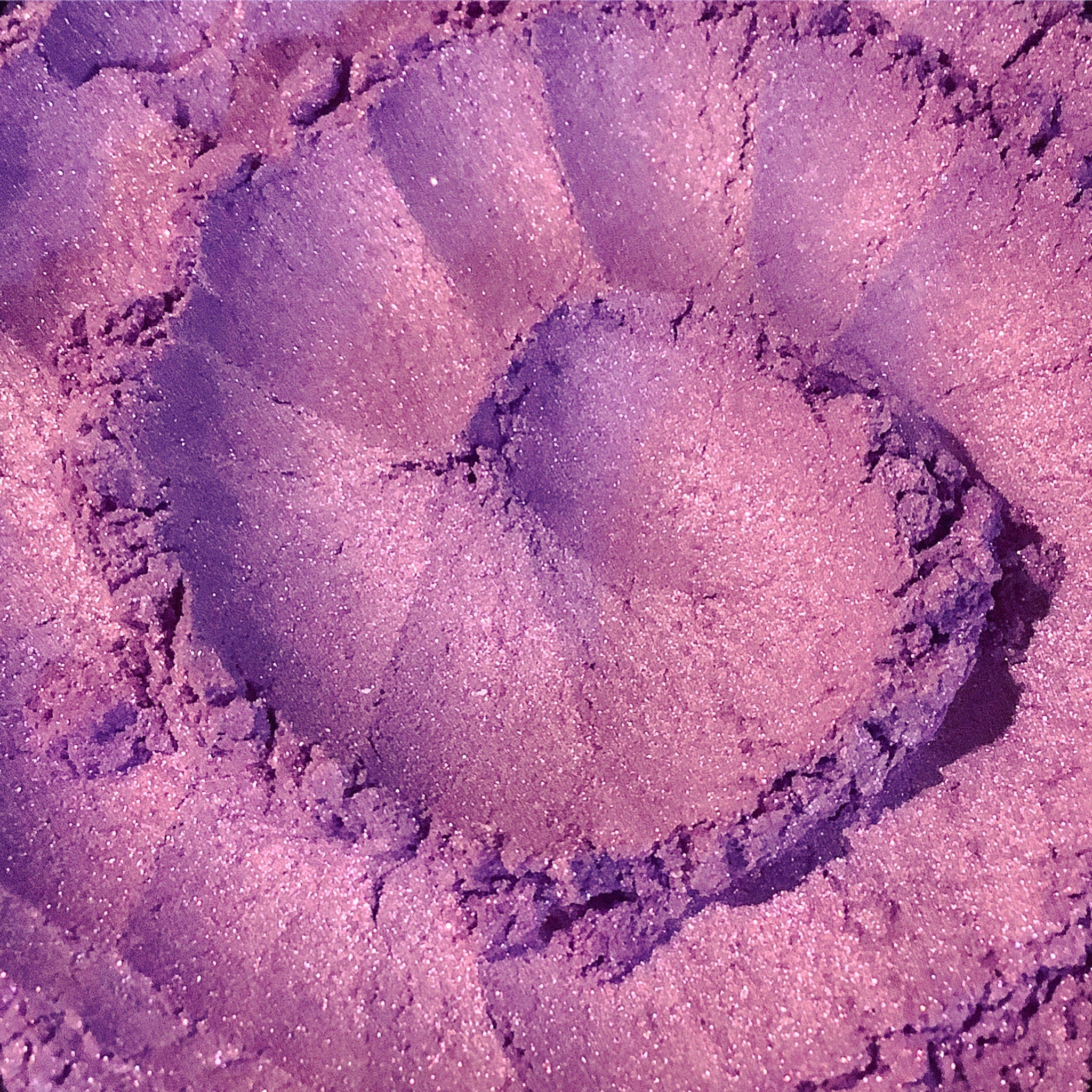 Purple eyeshadow powder with glittery texture and heart shape imprint