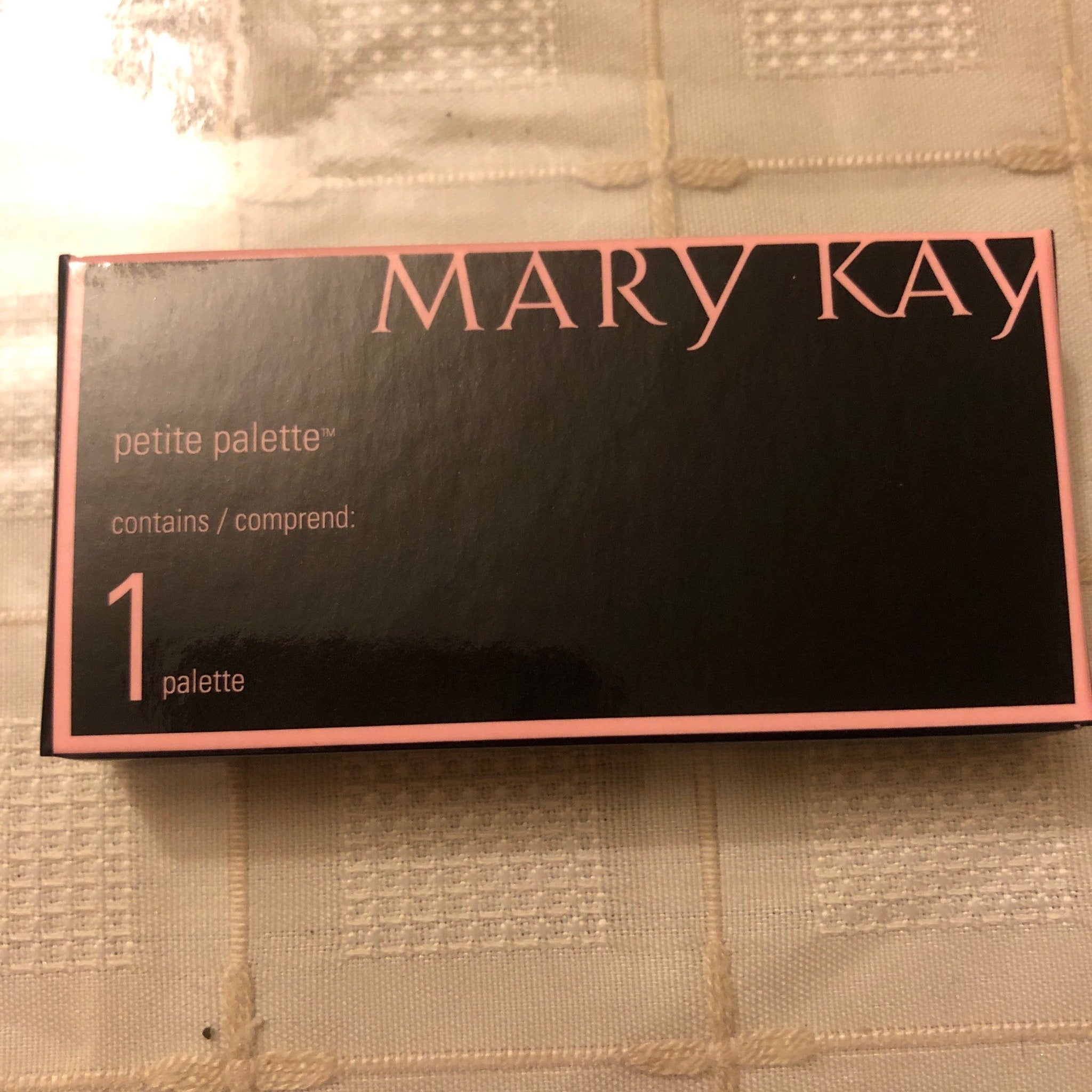 Close-up of Mary Kay Mini Eye Shadow Palette showing six vibrant powder shades in a sleek black compact