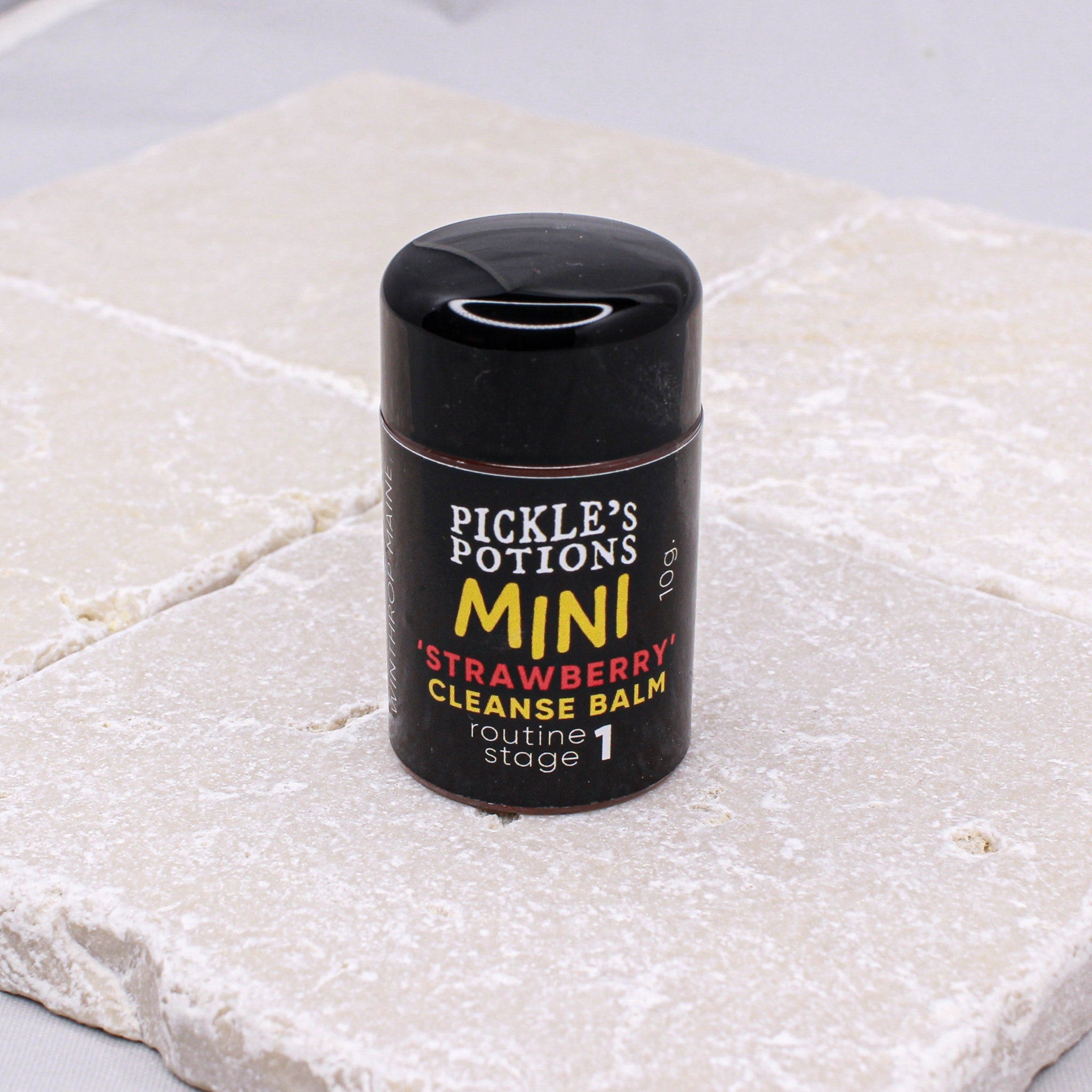 Mini cleanse balm in black and yellow label on stone surface, Pickle's Potions brand