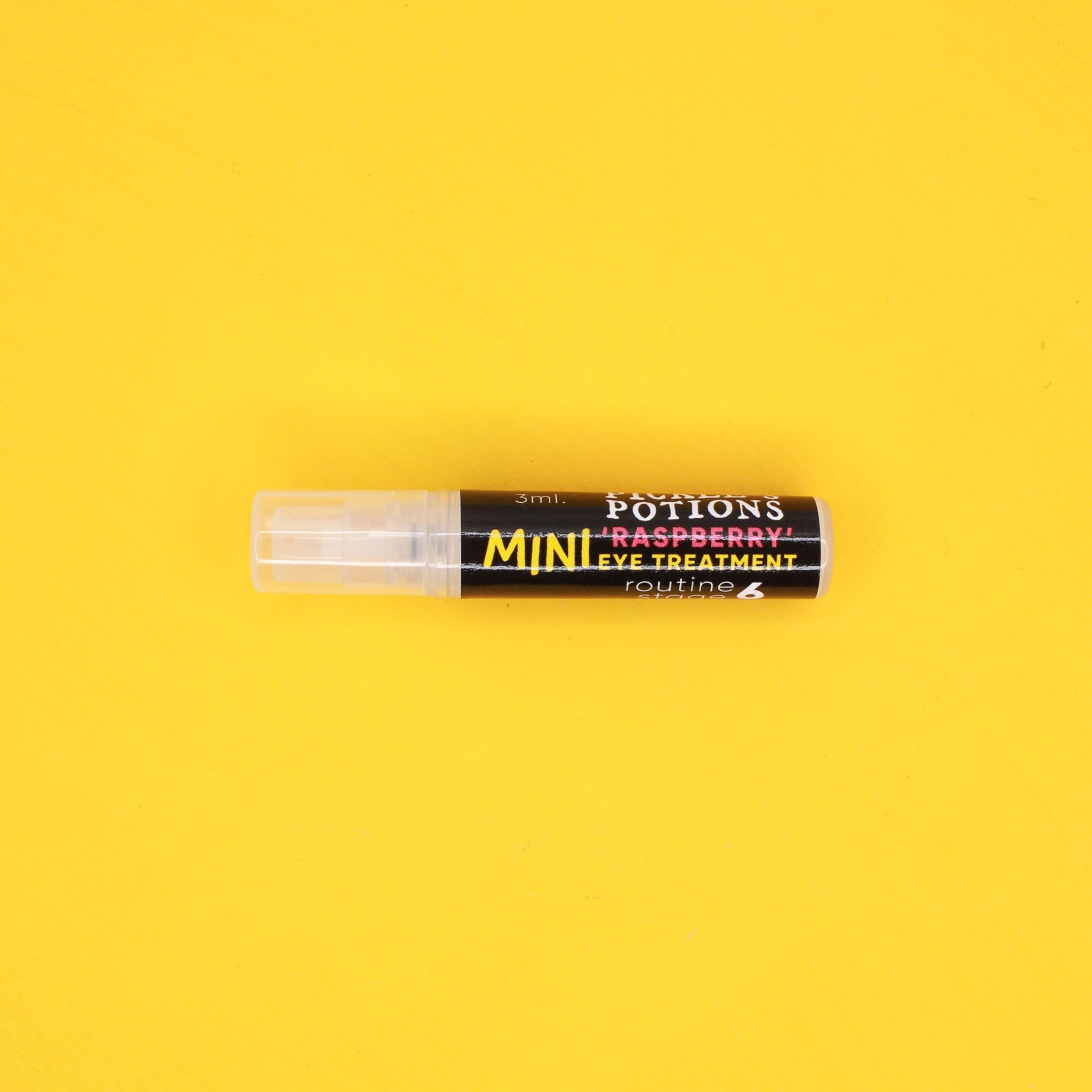 Eye treatment bottle with transparent cap, black and white label, and "MINI" text on yellow background