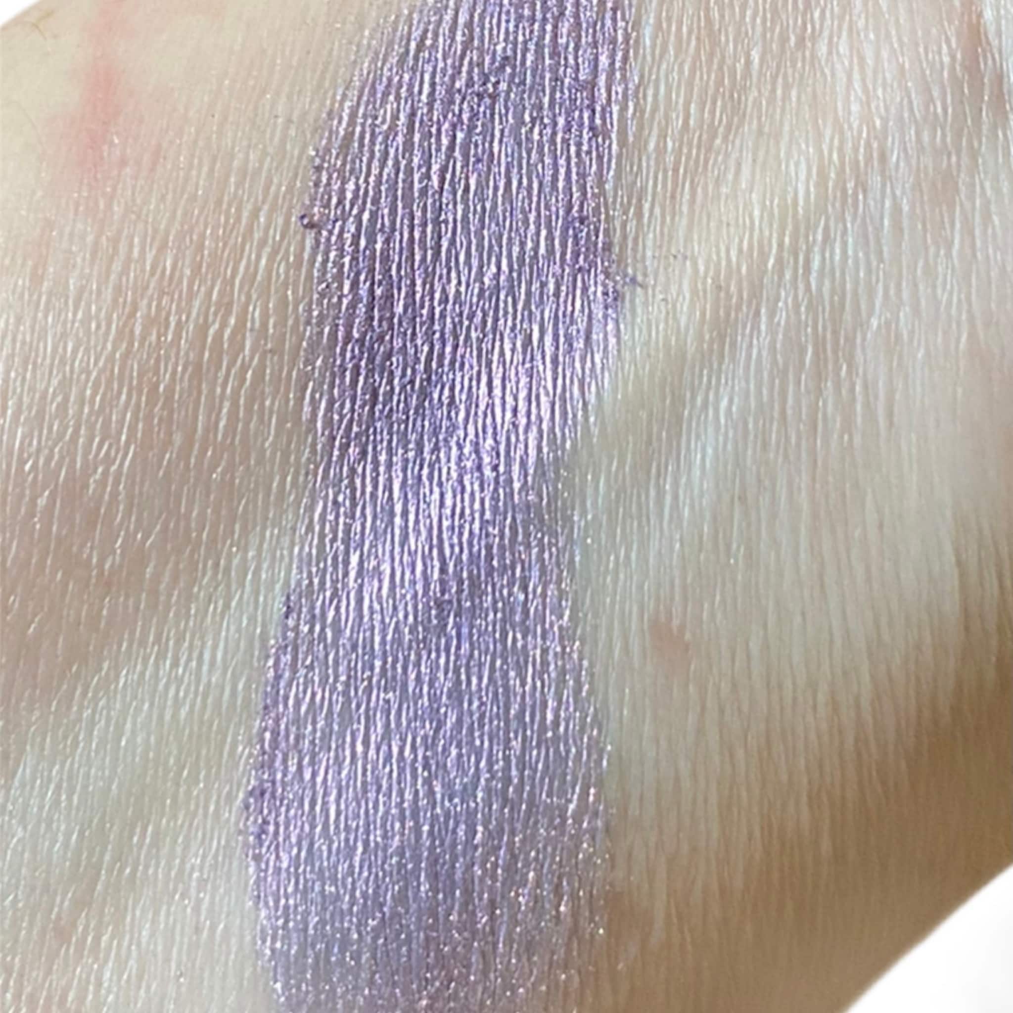 Eyeshadow swatch, lavender metallic color, textured application on skin