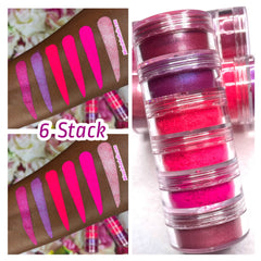 Stack of six neon pink eye shadows with matte and shimmer finishes in a slim rectangular palette