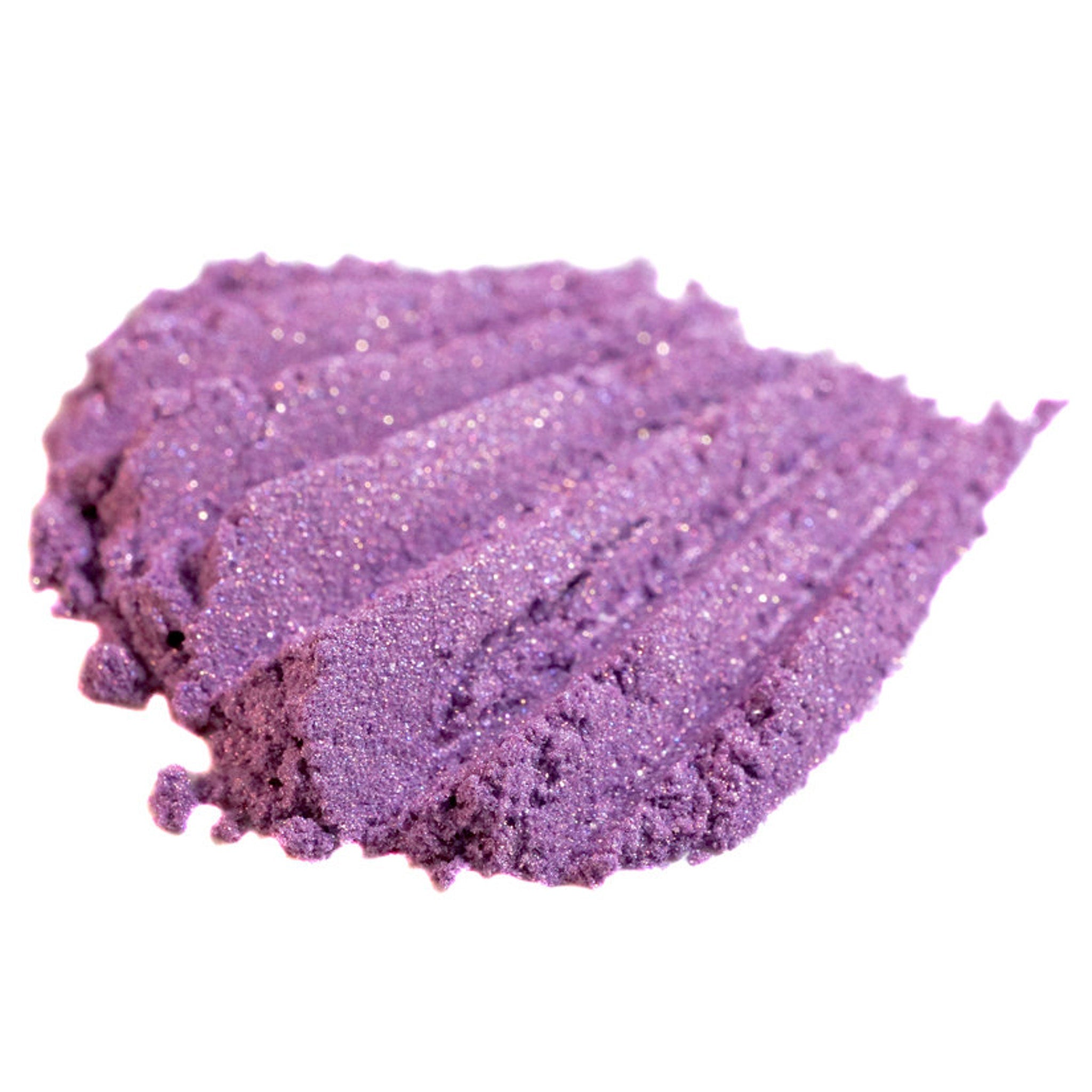 Purple eyeshadow swatch with glitter, textured surface, and light reflection