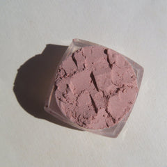 Close-up of loose sandy brown mineral eyeshadow with shimmer particles, vegan and cruelty-free.