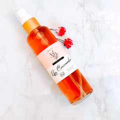 Rose face toner bottle, orange liquid, white and pink label, Nizzy Naturals branding