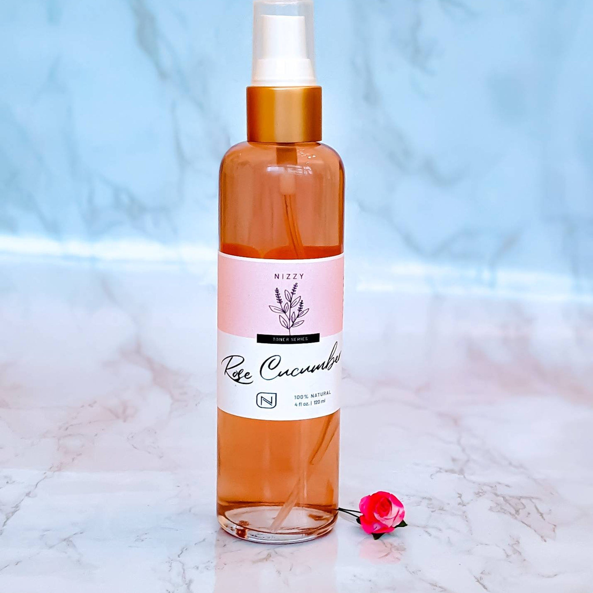 Rose Cucumber toner bottle with pink label, clear bottle, and gold cap, Nizzy brand