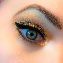 Eye makeup with gold eyeshadow, black eyeliner, and blue-green eye color, close-up view