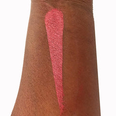 Close-up of a hand applying metallic bronze eyeshadow with a fluffy brush for a shimmering eyelid look