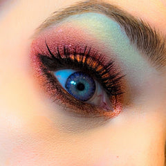 Side view of metallic eye shadow palette showing vibrant shimmer shades in compact case