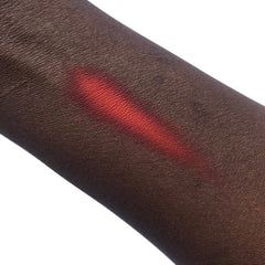 Red swatch on dark skin, showing color and texture