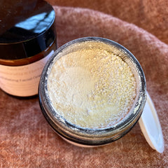 Exfoliating Facial Grains in open glass jar, pale yellow powder, Rosemary Gladstar label visible
