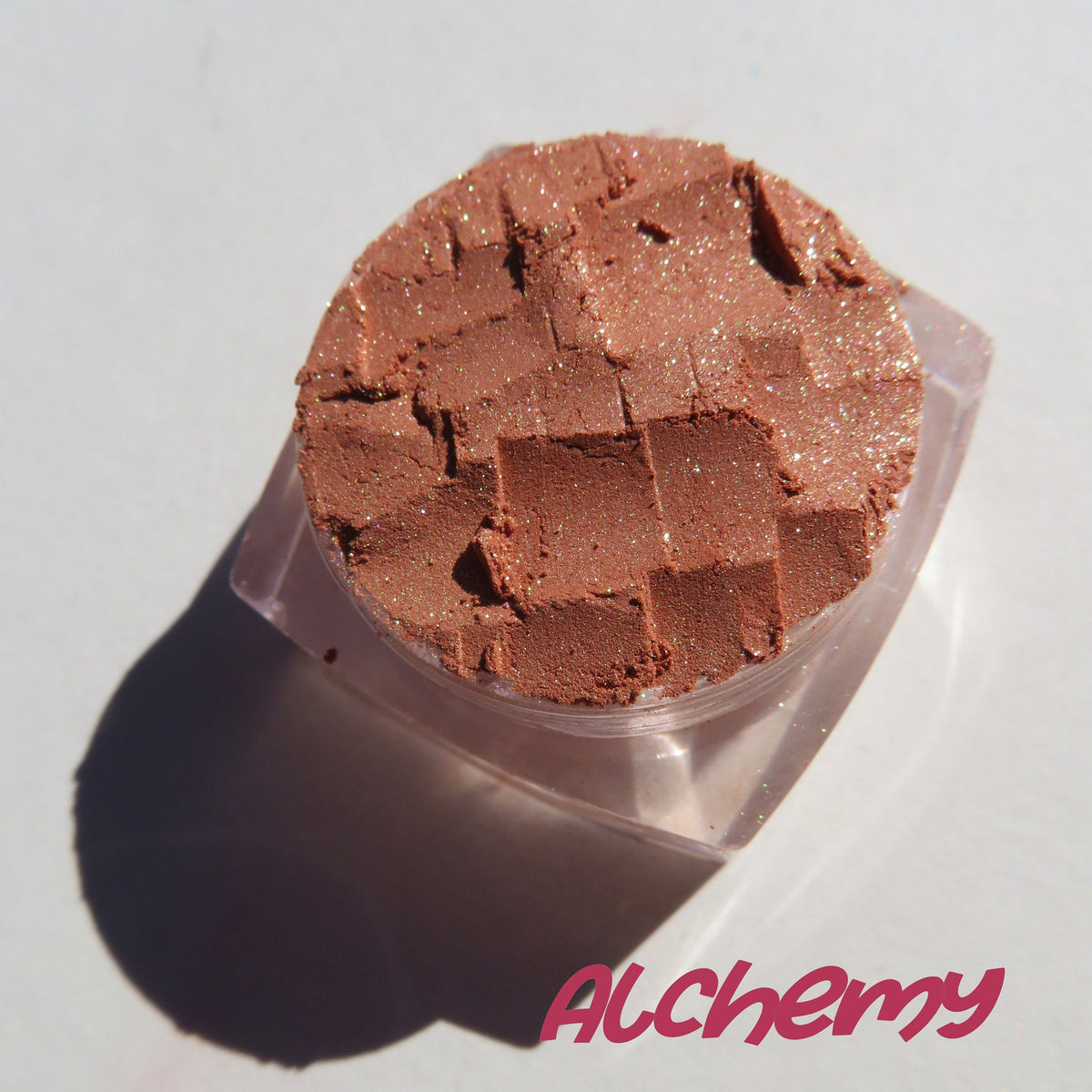 Open jar of brown gold loose mineral eyeshadow with golden shimmer, vegan and cruelty-free