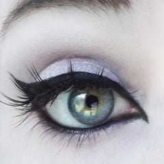 Eye makeup with blue-green eye, black eyeliner, and lavender eyeshadow for a dramatic look