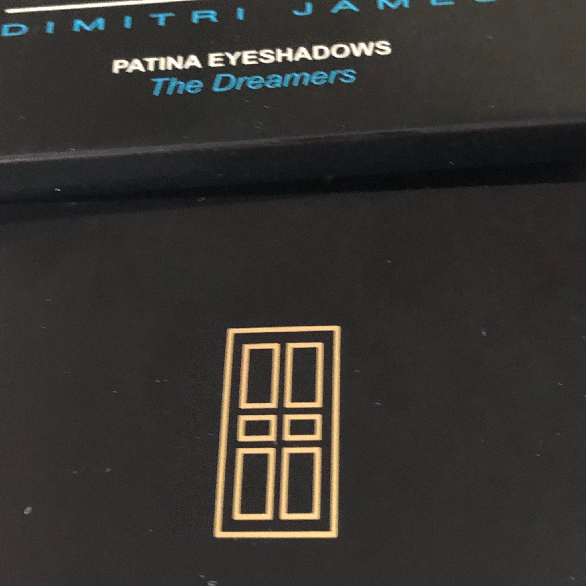 SKINN Patina Eye Shadows palette displayed open with six neutral-toned powder pans in sleek black compact