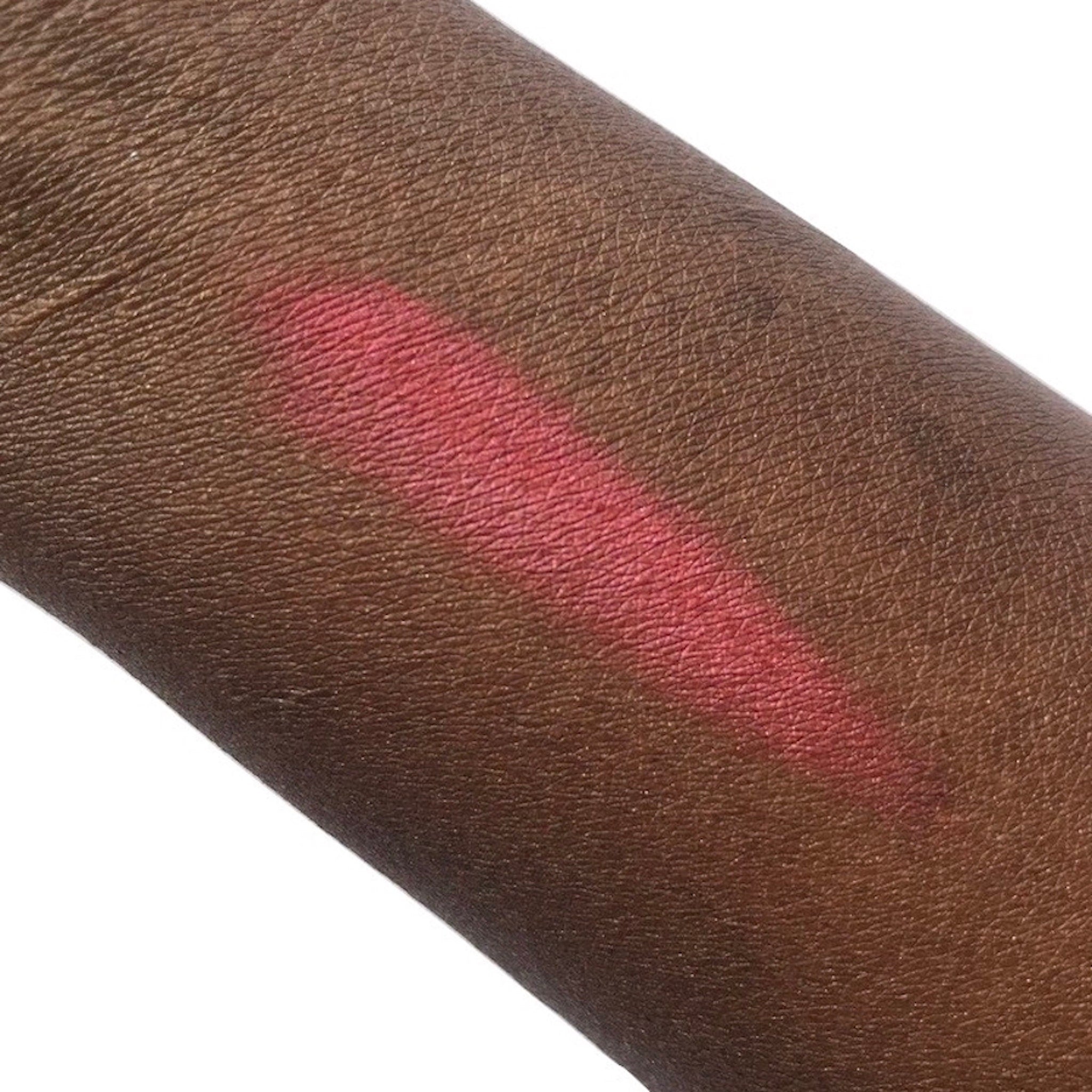 Side view of Altar of Roses mineral eyeshadow compact showing rose-gold packaging and pressed powder texture