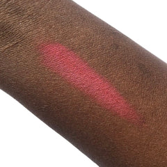 Side view of Altar of Roses mineral eyeshadow compact showing rose-gold packaging and pressed powder texture