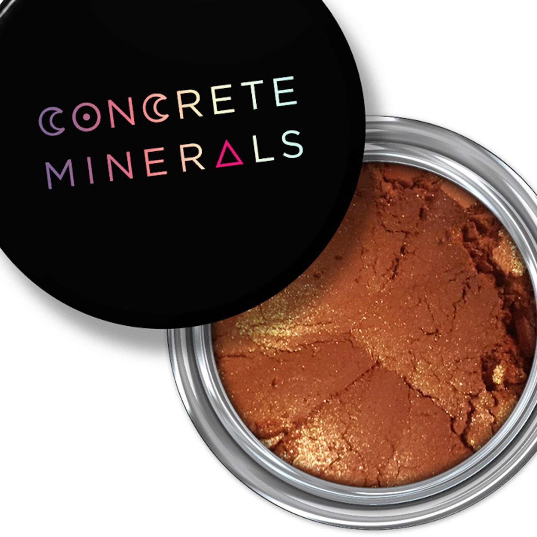 Mineral eyeshadow, brown powder in silver compact, Concrete Minerals brand name on black lid