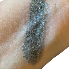 Close-up of dark silver metallic eyeshadow with intense shimmer finish in compact pan