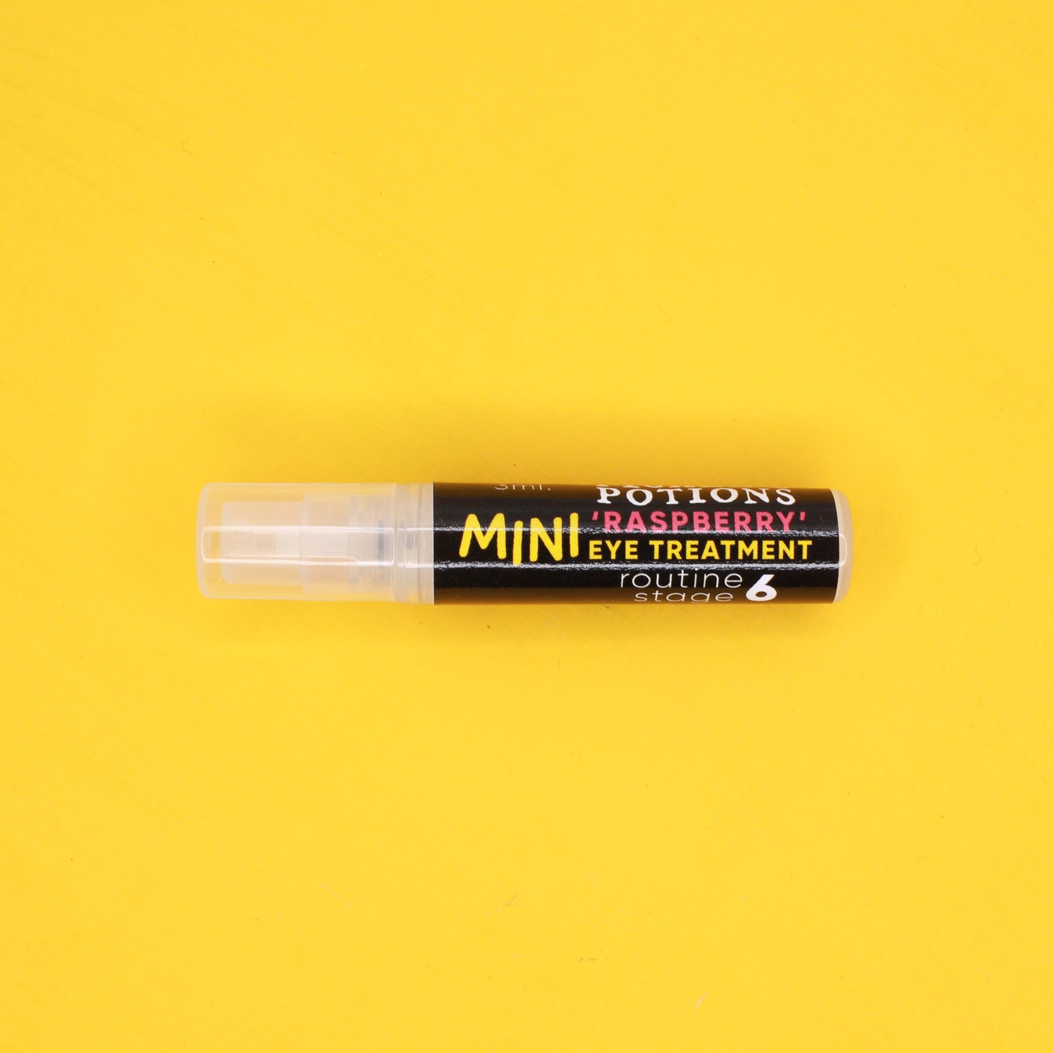 Eye makeup treatment, clear plastic tube, black label with Pickle Mini Raspberry text on yellow background