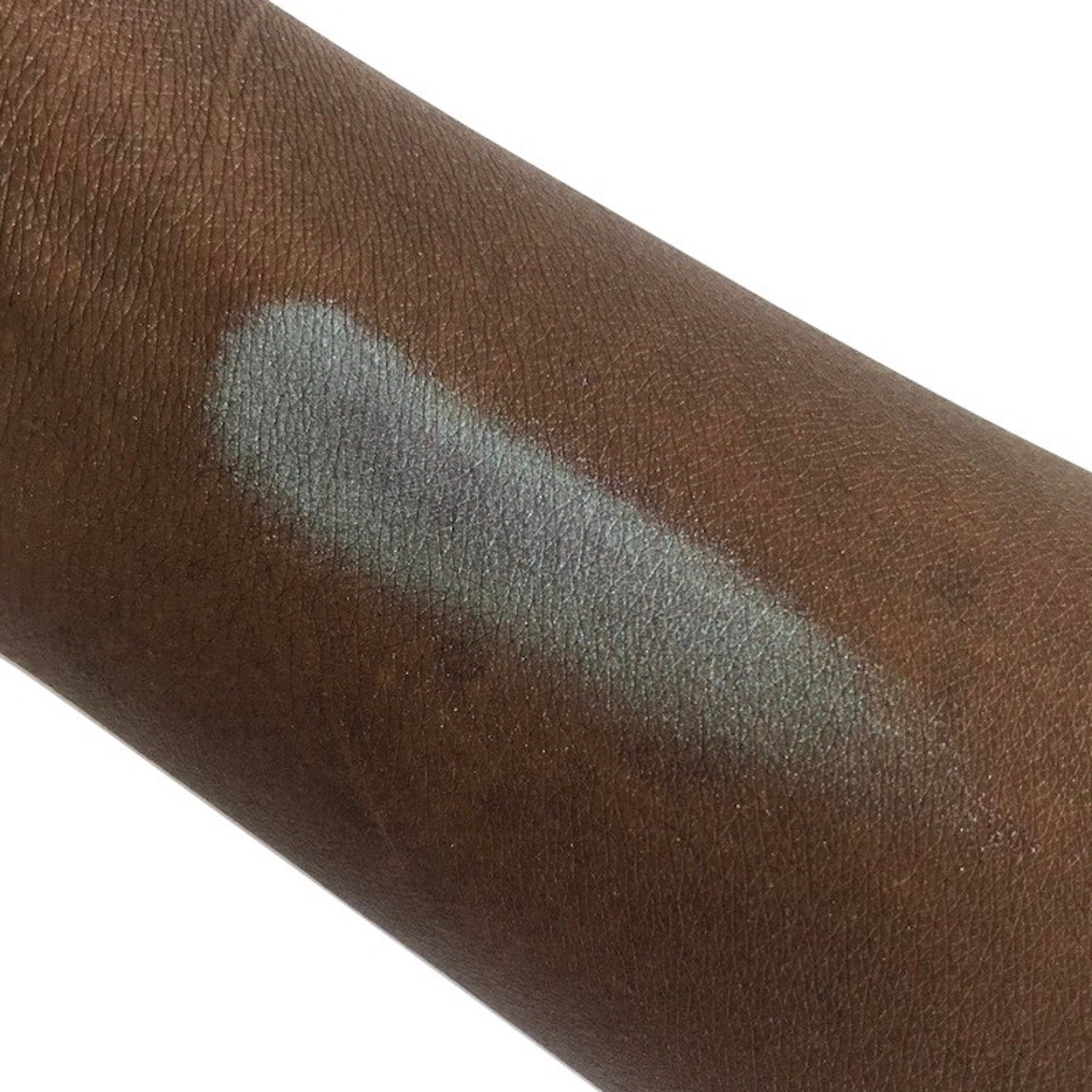 Eyeshadow swatch, pale blue shimmer, on dark skin, for color comparison