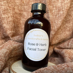 Facial toner bottle, brown glass, black cap, with Amber's Rose & Herb label on wood slice