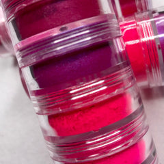 Side view of neon pink eyeshadow palette showing six vibrant matte and shimmer shades in rectangular pans