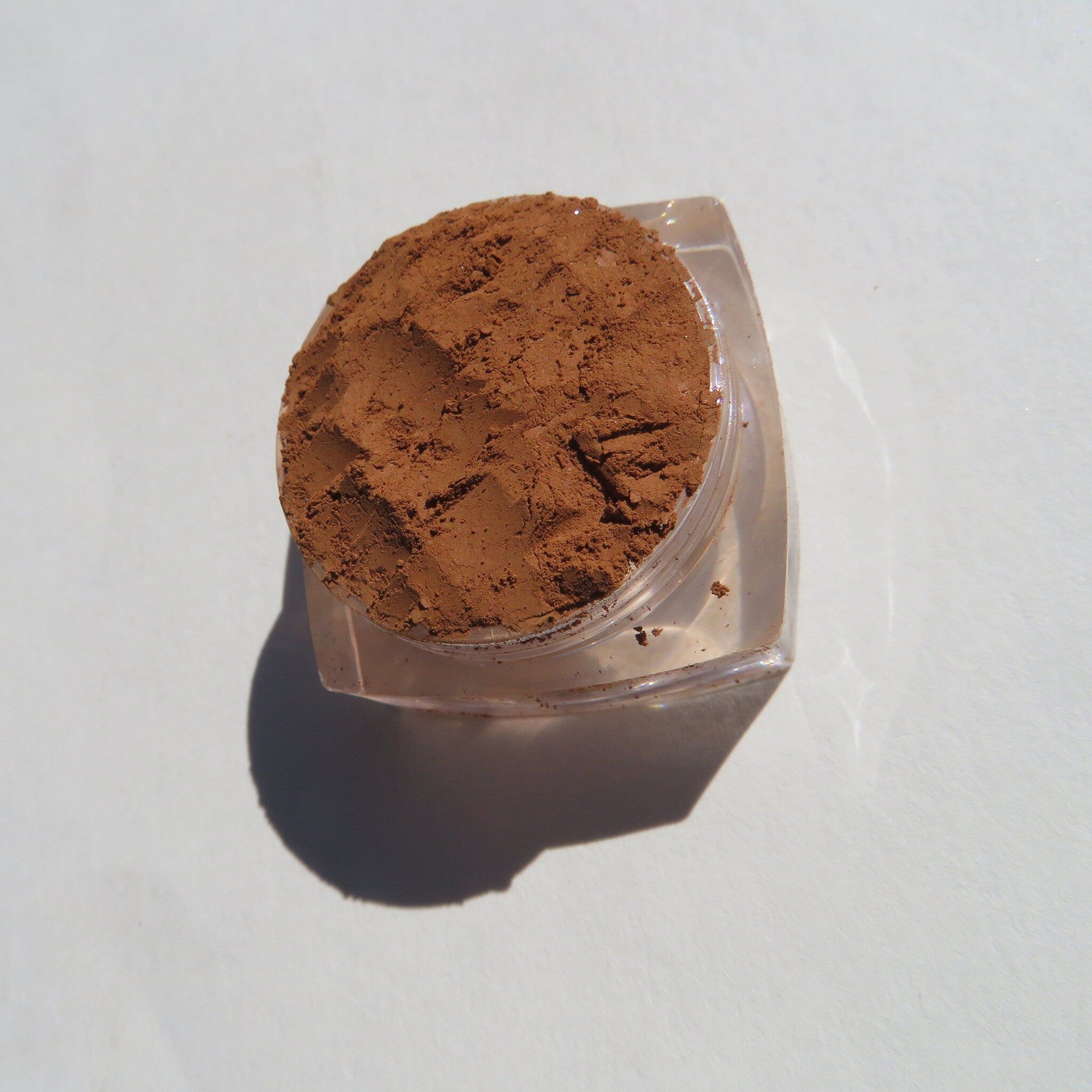 Open jar of Gingerbread Matte Mineral Eyeshadow showing sandy brown loose pigment with matte finish