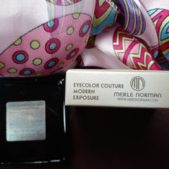 Eye shadow box with Merle Norman text, pink and patterned fabric, black container