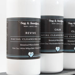 Facial cleansing grains in white bottles with black labels, Revive product name