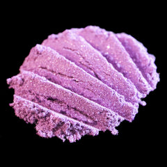 Loose eyeshadow, lavender purple shimmer, textured swatch on black background