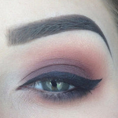 Eyeliner makeup with black wing, dark eyeshadow, and defined eyebrow for eye look