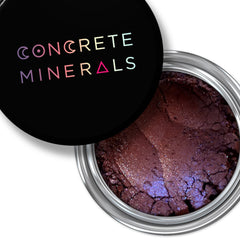 Mineral eyeshadow in brown with blue shimmer, in a silver jar, Concrete Minerals brand