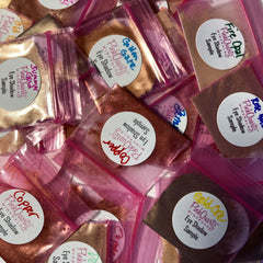 Open palette displaying 20 gold, bronze, and copper eye shadows with pink quartz minerals in rectangular pans