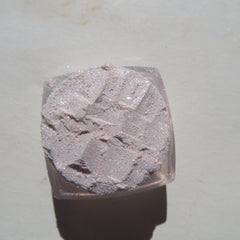 Close-up of sheer pink sparkly glitter eye shadow with shimmering vegan mineral particles