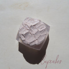 Close-up of sheer pink sparkly glitter eye shadow with shimmer in compact case