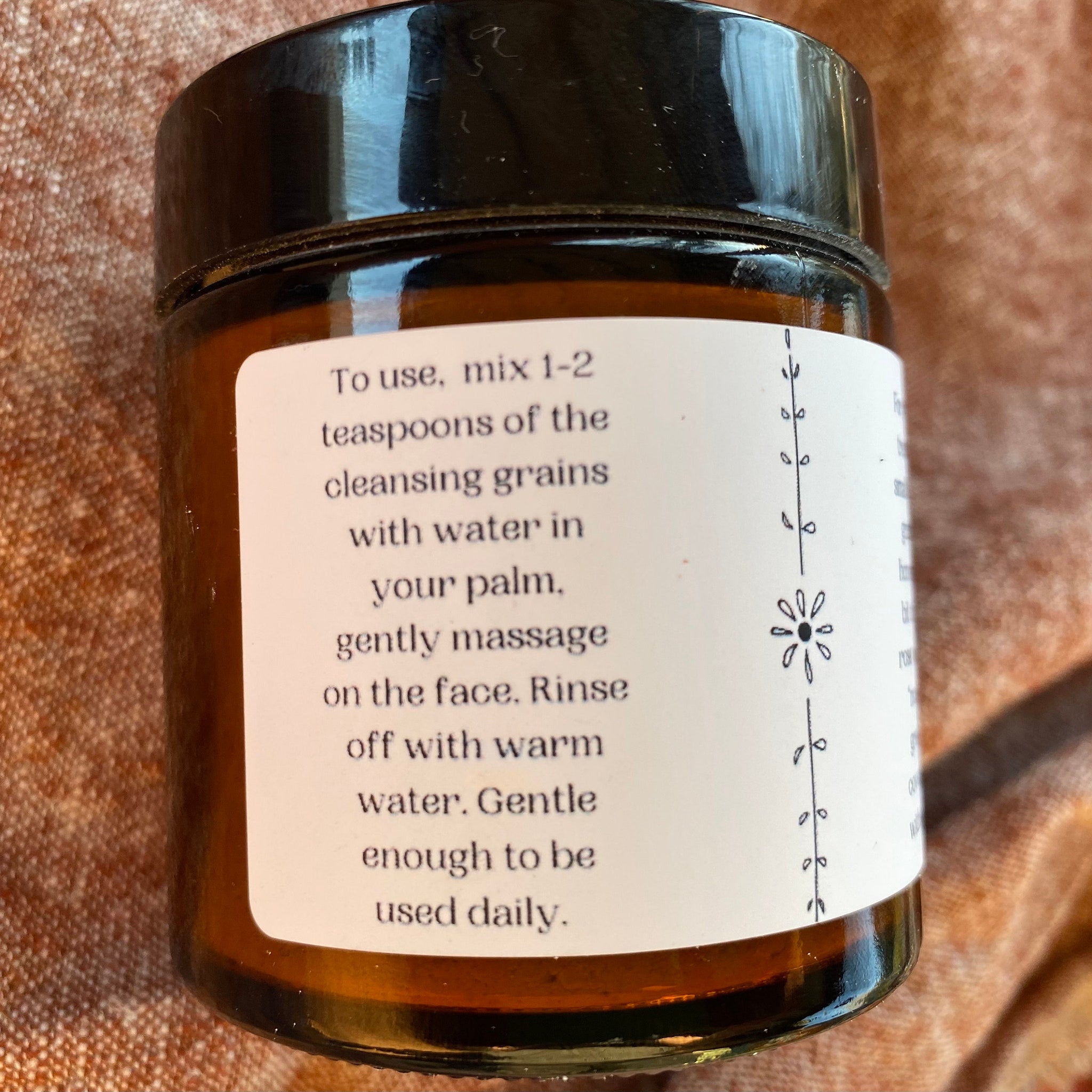 Cleansing grains jar, brown glass, black lid, white label with instructions