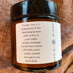 Cleansing grains jar, brown glass, black lid, white label with instructions