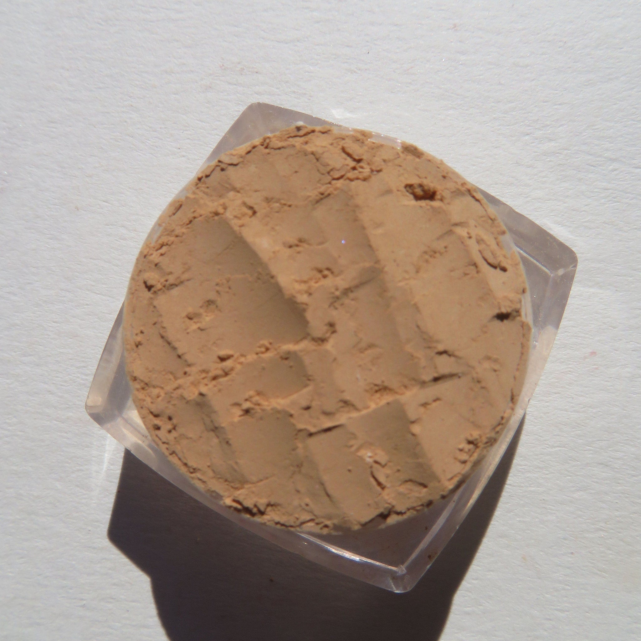 Powder compact, tan powder with textured surface in clear plastic container