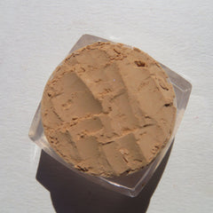 Powder compact, tan powder with textured surface in clear plastic container