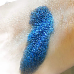 Blue eyeshadow swatch on skin, metallic shimmer, textured application