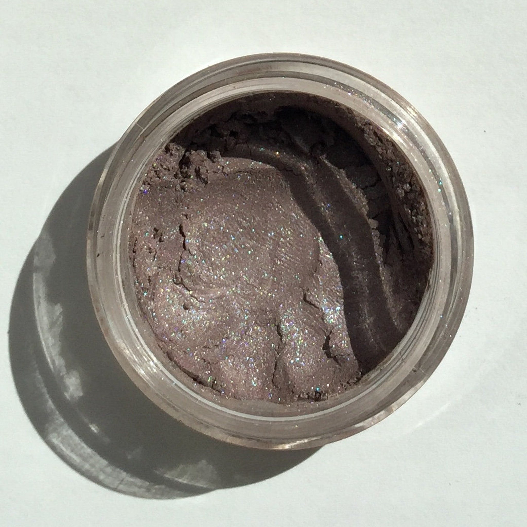 Close-up of Berrylicious Eye Shadow pan showing vibrant berry hue with satin finish