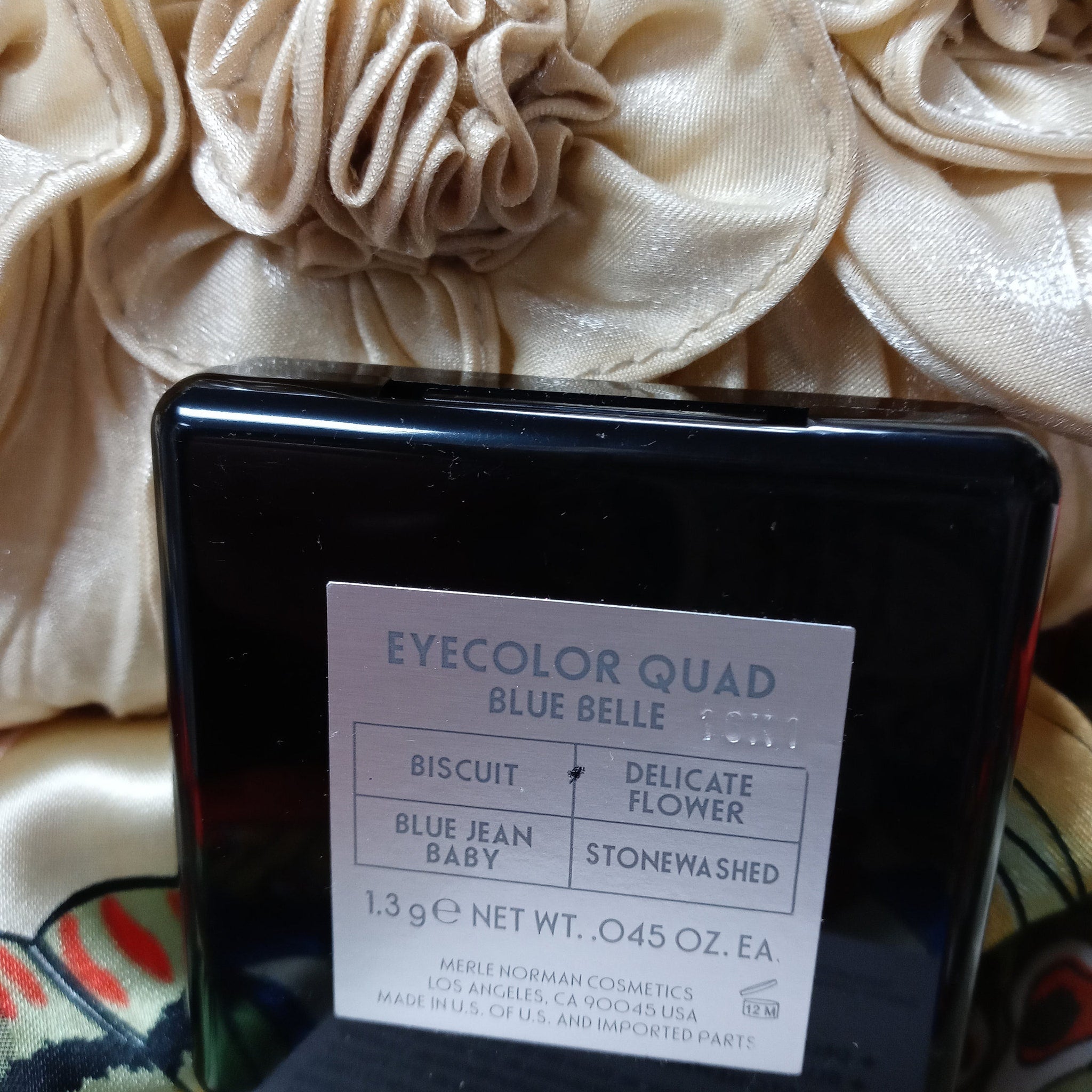 Open Merle Norman quad palette showing four matte and shimmer eye shadow shades in neutral tones