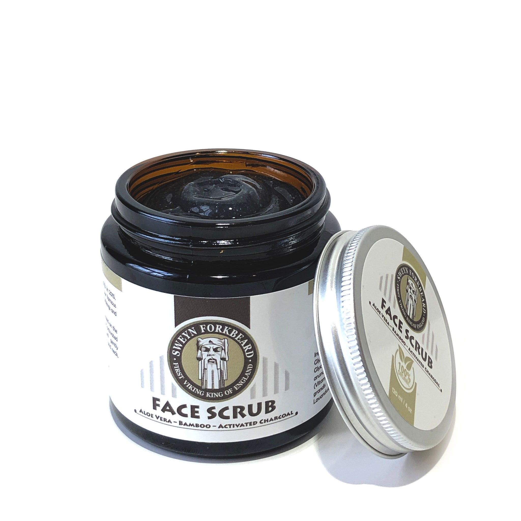Face scrub jar with brown glass, black cream, and silver lid, Sweyn Forkbeard brand visible