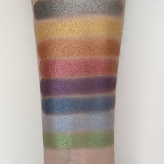 Side view of Vegan Churro Bronze Shimmer Pressed Eyeshadow pan showing warm bronze tones and reflective shimmer particles