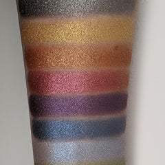 Close-up of fingertips applying bronze shimmer eyeshadow to eyelid with soft blending motion