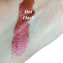Close-up of shimmering red eyeshadow with metallic luster in compact case